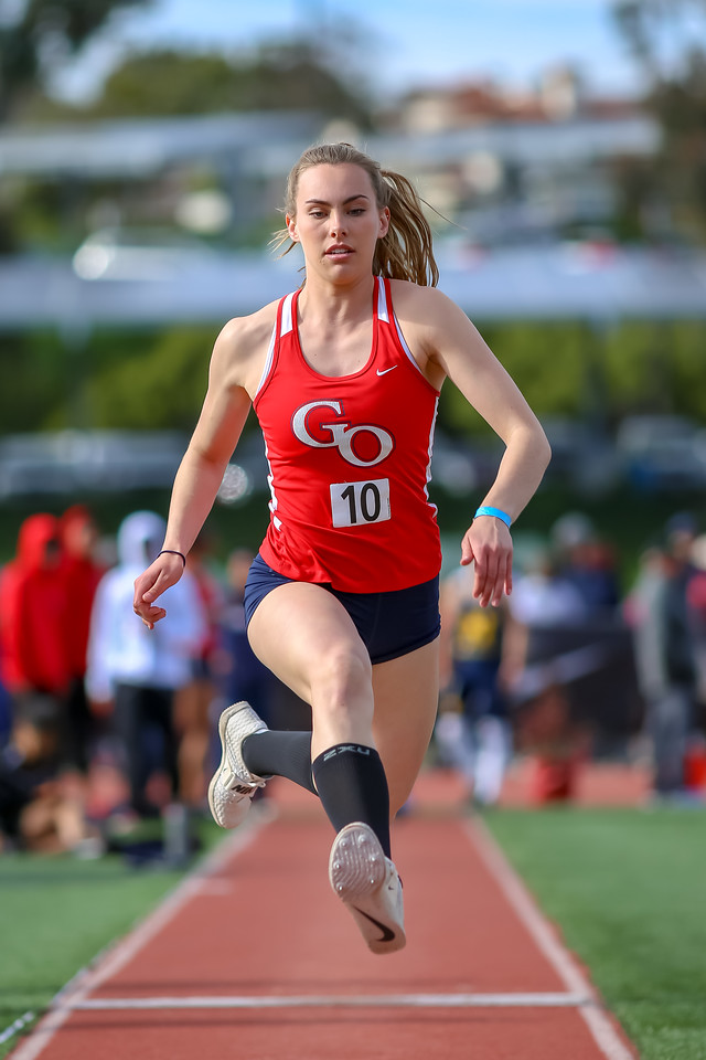 Long jumper launching down the runway
