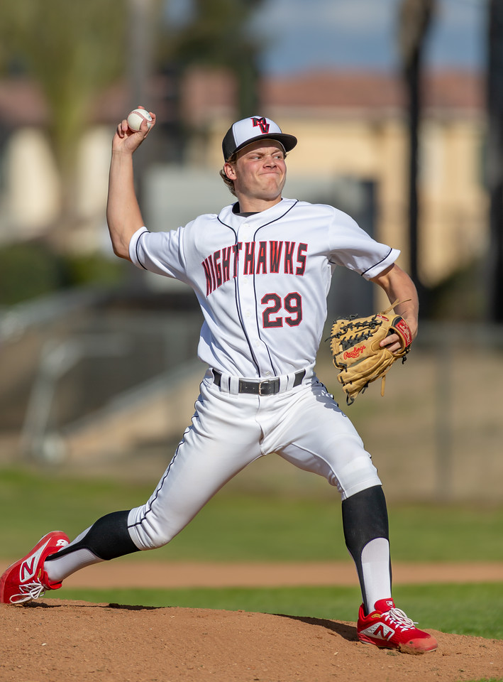 Pitcher in mid-delivery on the mound