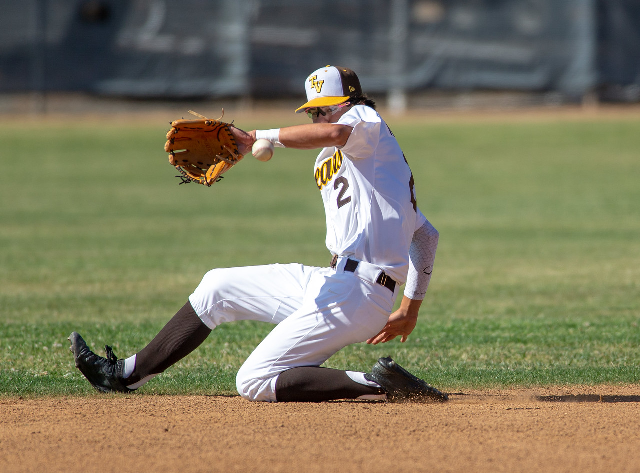 Infielder stretching to scoop a throw