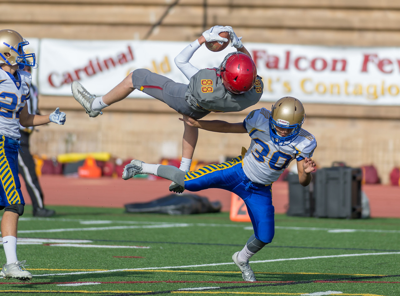 Football player flipping mid-air during a tackle