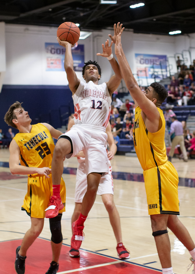 Player rising for a jump shot over defenders
